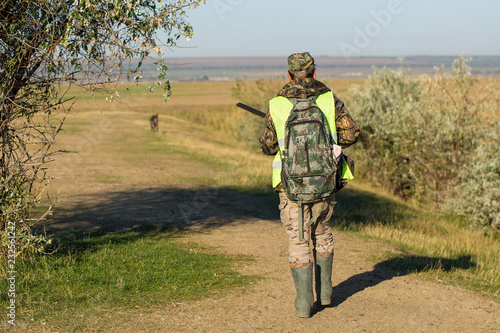 Hunters with a german drathaar and spaniel  pigeon hunting with dogs in reflective vests 