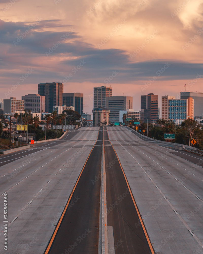 Empty San Diego Freeway with Sunset Sky - Vertical view of San Diego, California, USA Skyline with empty freeway in foreground. The 5 freeway travels most of the coast of the western united states