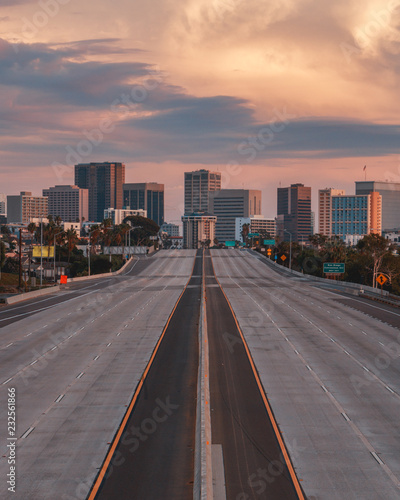 Empty San Diego Freeway with Sunset Sky - Vertical view of San Diego, California, USA Skyline with empty freeway in foreground. The 5 freeway travels most of the coast of the western united states