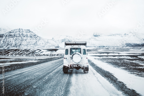 car on winter road in Iceland photo