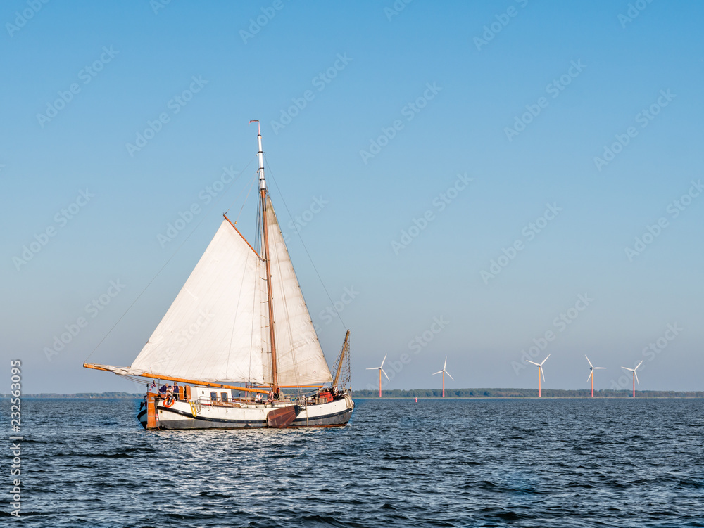 People sailing on traditional sail barge tjalk on Markermeer, Netherlands
