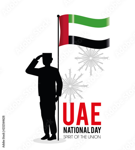 soldier with uae flag to celebrate national day photo