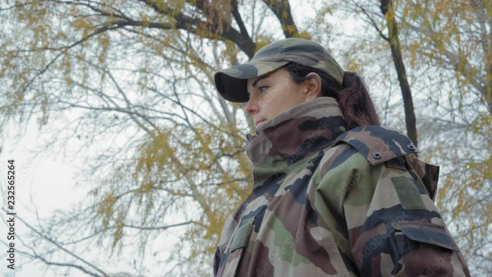 Close-up, Beautiful Fisherwoman Girl in Camouflage Suit Throws a Fishing Rod into the River in a Cold Foggy Morning Close-up, Beautiful Fisherwoman Girl in Camouflage Suit Throws a Fishing Rod into the River in a Cold Foggy Morning