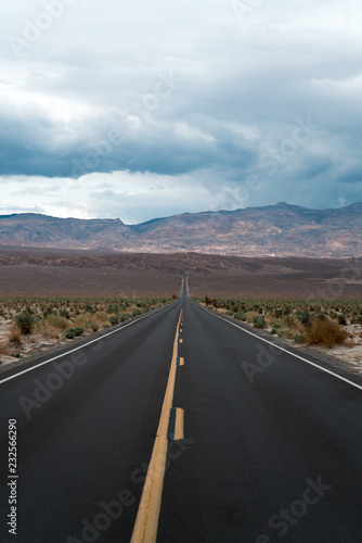 Storm clouds roll in over the desert road in Death Valley