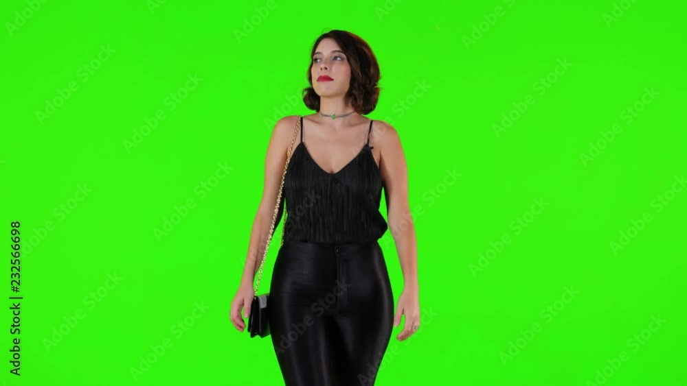 Pretty woman walking for a date night over a green screen in a medium frontal shot. Pretty woman walking for a date night over a green screen in a medium frontal shot.