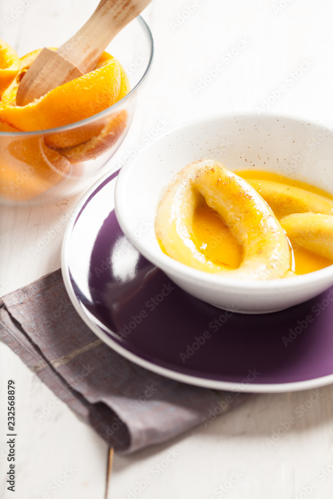 Fried bananas in orange sauce, a delicious dessert from fruits, butter and cognac.