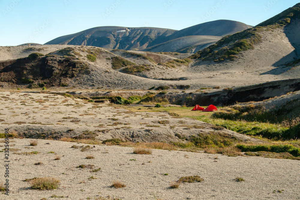 Tents at a hot spring oasis in the desert on the Banos de Caulle Trek, Patagonia, Chile