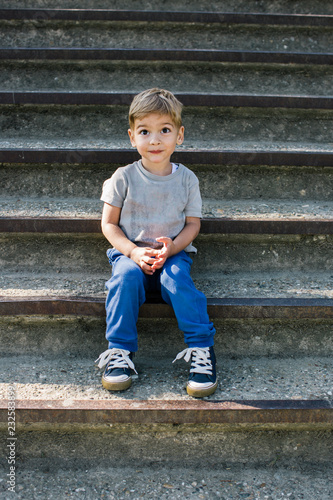 Cute Boy Sitting on a  Staircase Outdoors photo