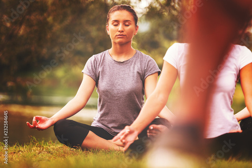 women meditating and doing yoga exercise