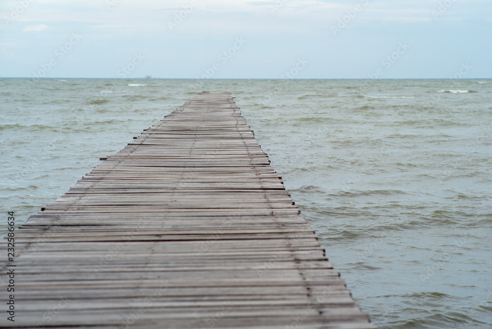 Abstract texture and background of wooden walkway into the sea. Wood bridge at the shore into the ocean