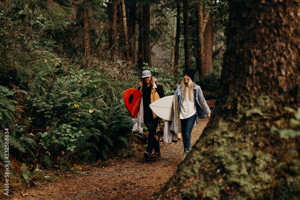 Couple hiking to surf beach Couple hiking to surf beach