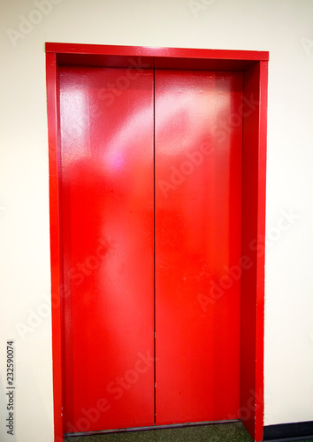 freshly painted red elevator doors