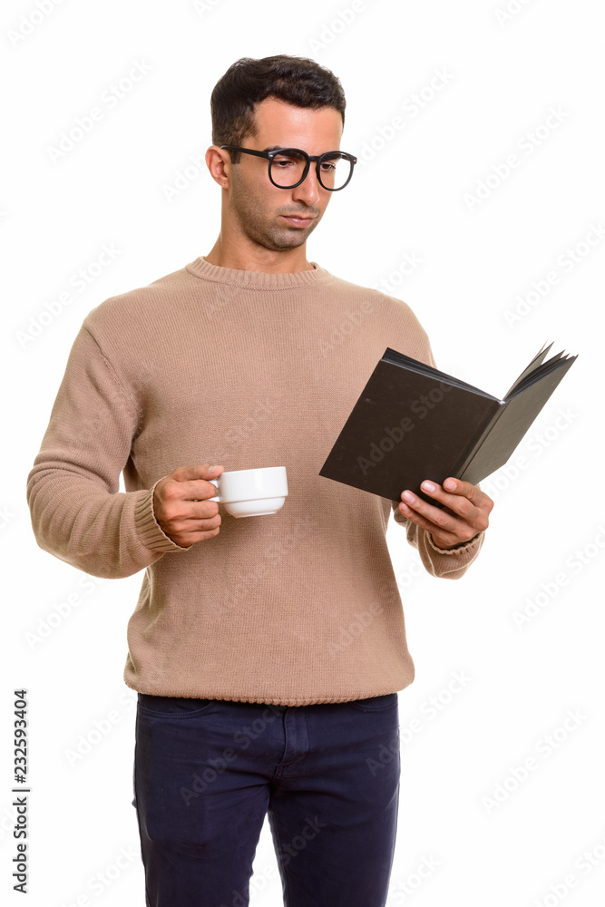 Portrait of young handsome Persian man reading diary or book Portrait of young handsome Persian man reading diary or book