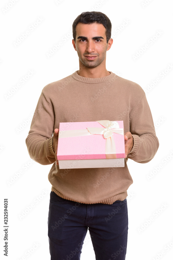 Portrait of young handsome Persian man holding gift box Portrait of young handsome Persian man holding gift box