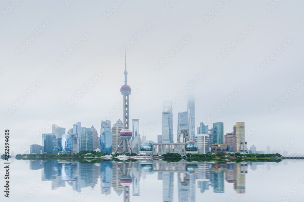 ShangHai，China. In cloudy weather, the buildings are reflected on the water and through clouds