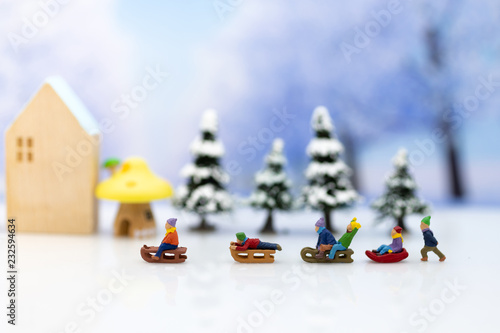 Miniature people: Children playing on snow funny together. Image use for Christmas festival