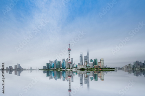 ShangHai，China. In cloudy weather, the buildings are reflected on the water and through clouds