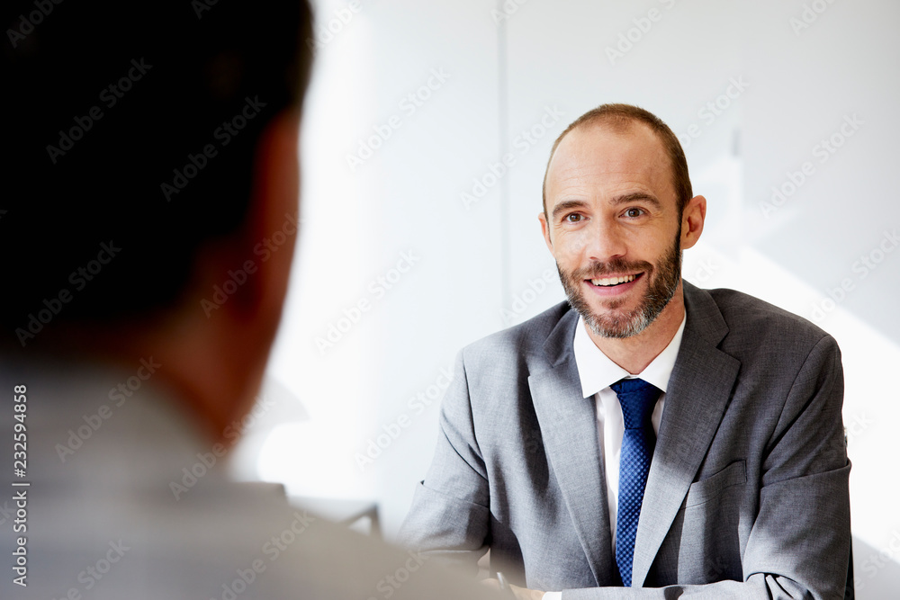 Smiling Businessman With Colleague In Office Smiling Businessman With Colleague In Office