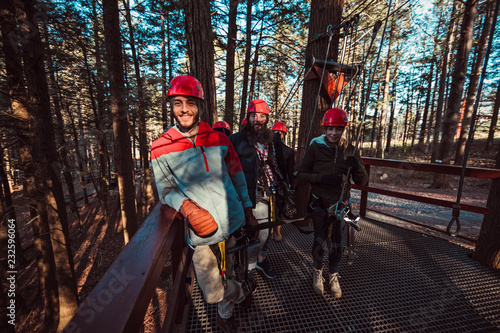 Wallpaper Mural Friends pose on an outdoor deck before starting their zip line adventure Torontodigital.ca