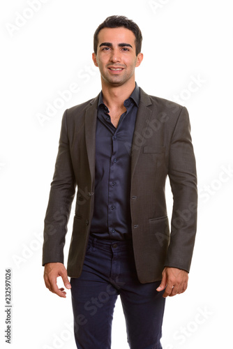 Portrait of young happy Persian businessman against white background