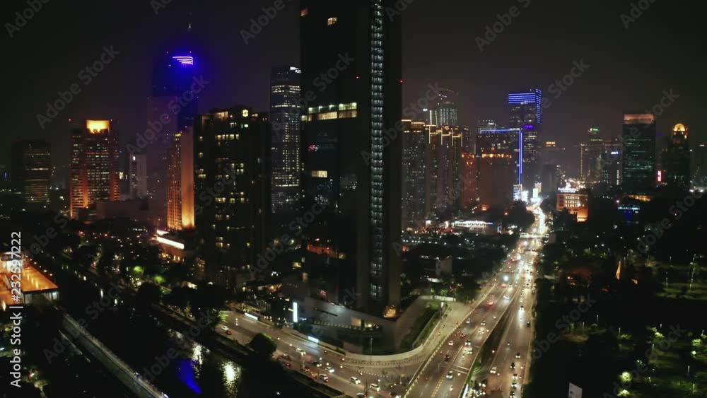 JAKARTA, Indonesia - November 08, 2018: Aerial view of night traffic on the highway with skyscrapers background and night light view. Shot in 4k resolution JAKARTA, Indonesia - November 08, 2018: Aerial view of night traffic on the highway with skyscrapers background and night light view. Shot in 4k resolution