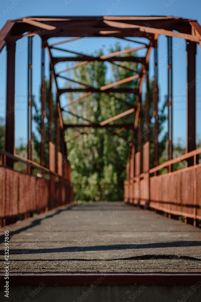Old metal construction of empty pedestrian bridge in city Old metal construction of empty pedestrian bridge in city
