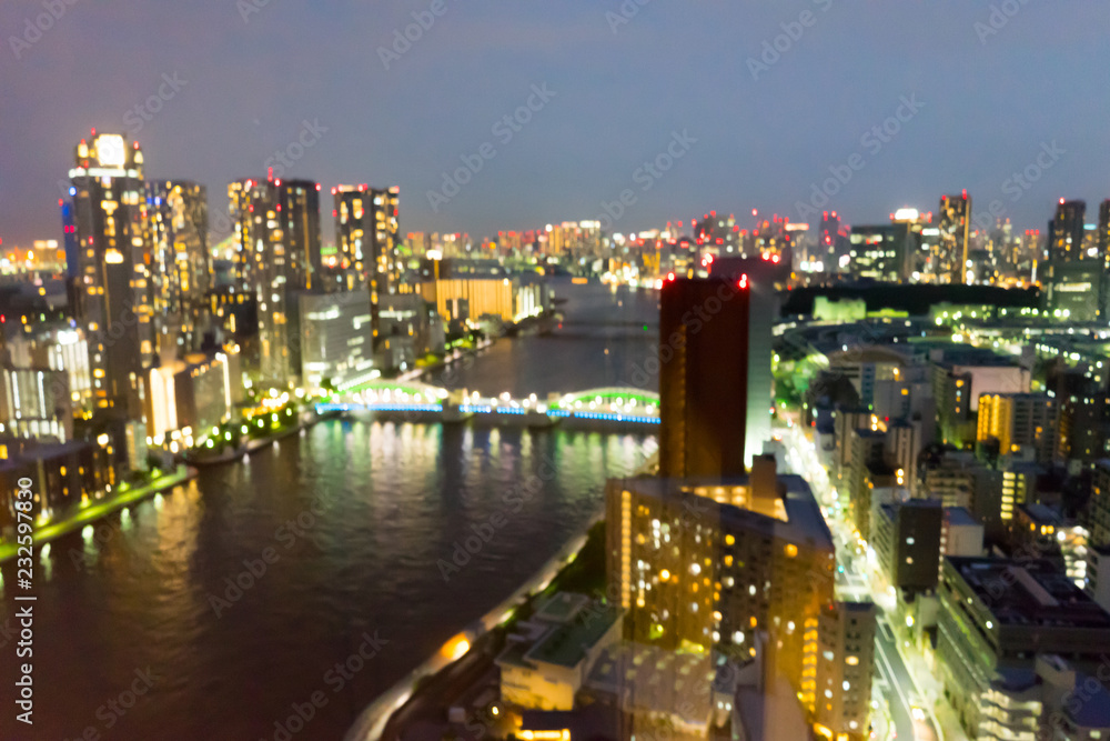 Obraz premium Lights shining from a big city block in the bright night in a blur.