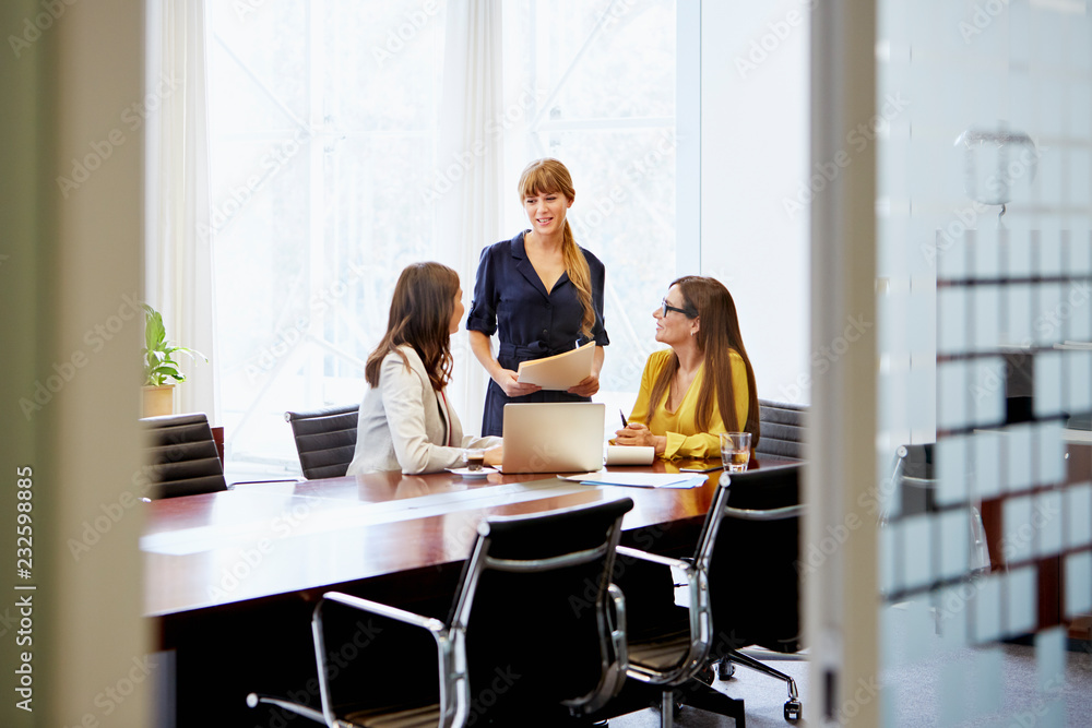 Confident Businesswomen Discussing At Table Confident Businesswomen Discussing At Table