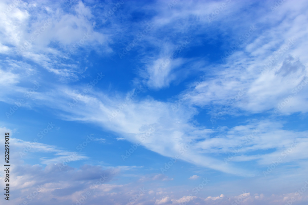 Beautiful clear blue sky background with white clouds.