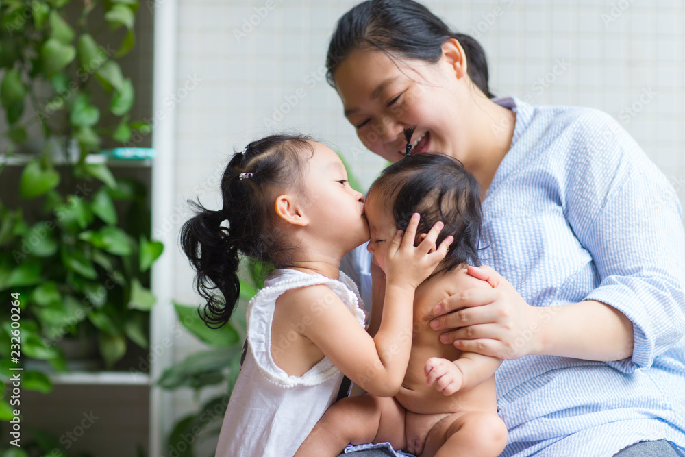 Asian mother with her baby girl in home Asian mother with her baby girl in home