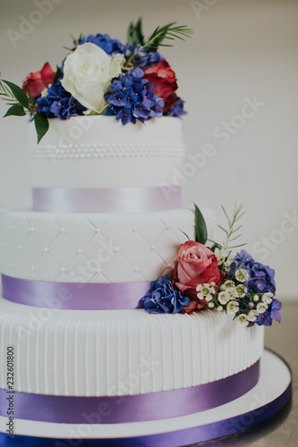 Colorful purple and white designer wedding cake
