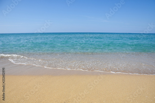 Tropical beach with turquoise clear water. Summer sandy beach with a blue sea water