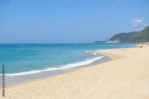 Tropical beach with turquoise clear water. Summer sandy beach with a blue sea water