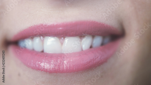 Close up beautiful smiling pink lips of young girl with teeth © emaria