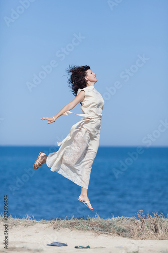 Girl jumps against sea
