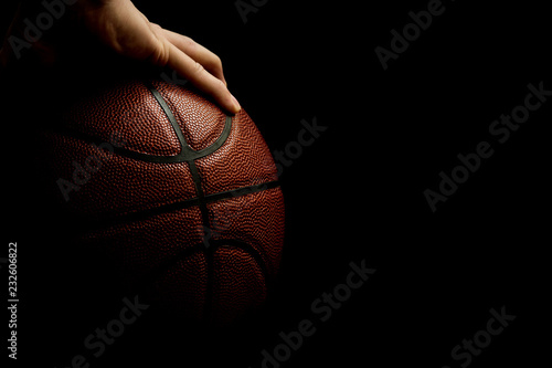 Man's One Hand Palming Leather Basketball Isolated On Black Background, Room For Text