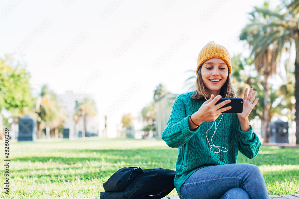 Young woman making a video call on the street. Young woman making a video call on the street.