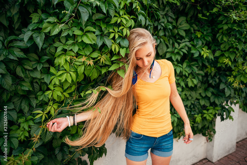 beautiful girl in shorts and yellow shirt outdoors beautiful girl in shorts and yellow shirt outdoors