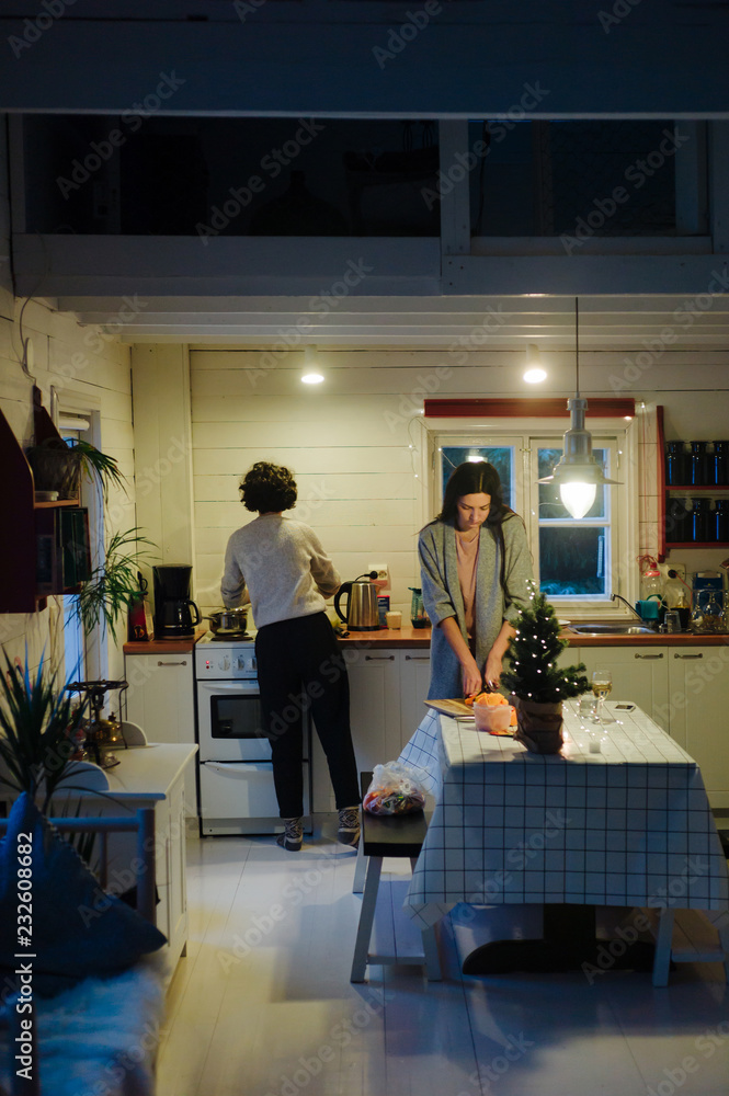Women in cozy kitchen preparing meal Women in cozy kitchen preparing meal