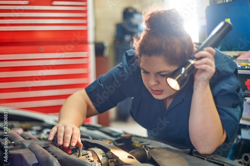 Female Mechanic Working on Cars in Her Shop photo