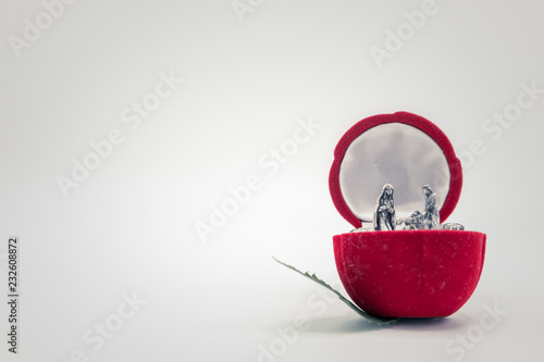 Fotografija Christian nativity scene on a red rose flower. Left copy space.