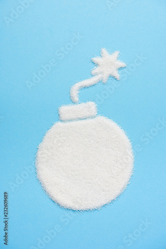 The bomb made of sugar on blue blue background. Diabetes concept. Sugar Kills. Suggesting dieting concept. Unhealthy white sugar concept. Copy space. Space for text.