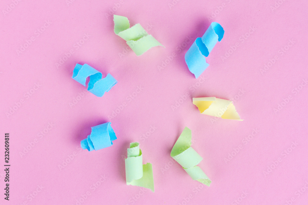 Festive background. Celebration concept. Colorful party streamers on a pink background. Copy space Festive background. Celebration concept. Colorful party streamers on a pink background. Copy space