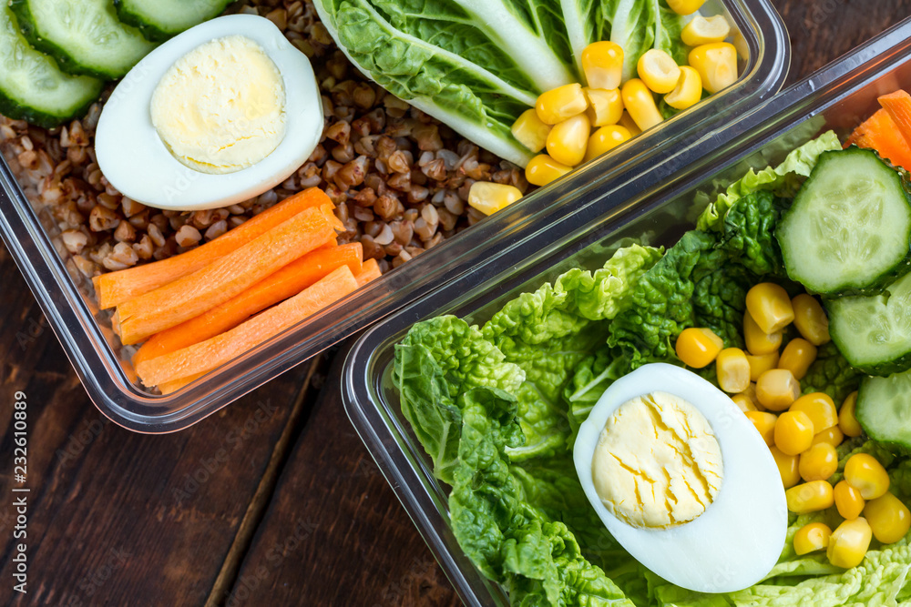 Healthy meal in a plastic container. Snack in the office, at work. Lunch box on a wooden background. Proper and healthy food concept. Diet Healthy meal in a plastic container. Snack in the office, at work. Lunch box on a wooden background. Proper and healthy food concept. Diet