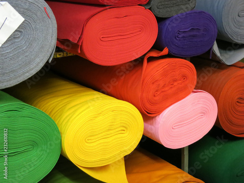 rolls of felt on a plank in different colors photo