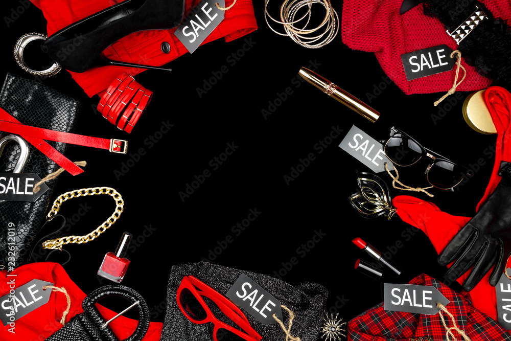 Woman's accessories and fashion clothes as: wallet, purs, black high heels , earnings, red nail polish and lipstick isolated on black background. Black friday, sale and discount in shop store concept