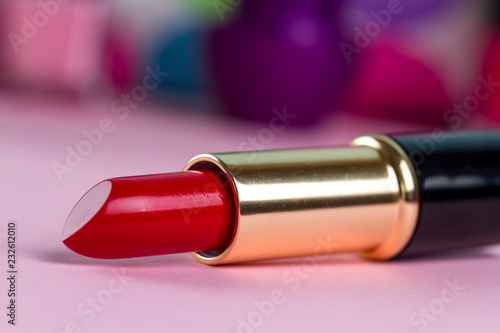 Red lipstick on the background of women s cosmetic bag. Women s cosmetics for professional makeup