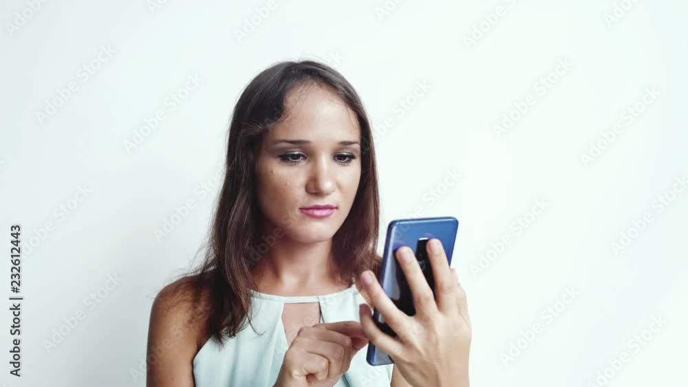 Business woman uses mobile phone press by media or social networks on a white background. close up. 3840x2160 Business woman uses mobile phone press by media or social networks on a white background. close up. 3840x2160