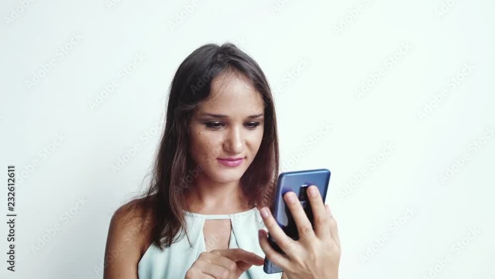 Happy businesswoman uses mobile phone press by media or social networks on a white background. close up. 3840x2160 Happy businesswoman uses mobile phone press by media or social networks on a white background. close up. 3840x2160