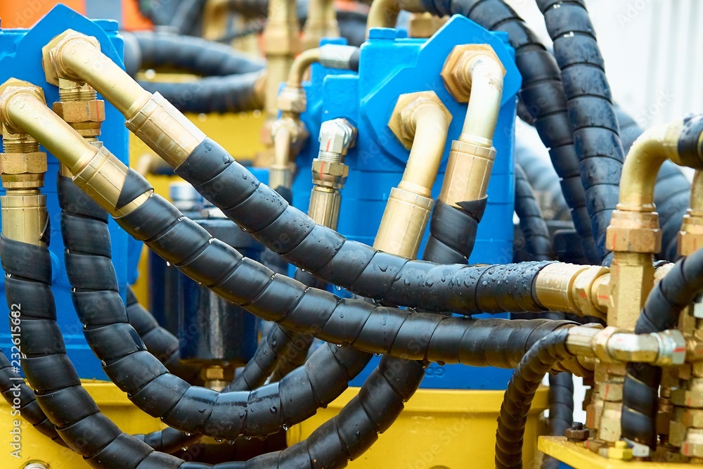 Closeup of manometer, measuring gas pressure. Pipes and valves on the background. Selective focus. Closeup of manometer, measuring gas pressure. Pipes and valves on the background. Selective focus.